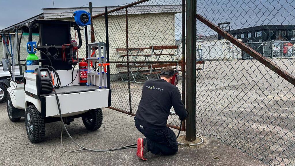 Quietly powering a welding machine, the Paxster Utility facilitates fence repairs without the noise of a traditional generator.